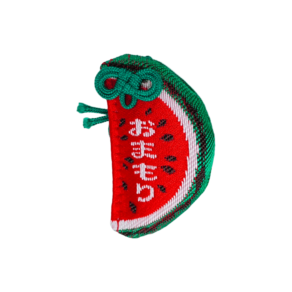 Watermelon slice-shaped Japanese Omamori charm in red, black, and green, embroidered with the word Omamori.